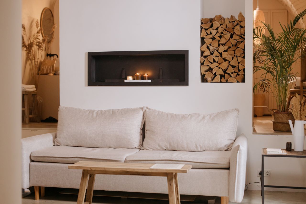 Crafting Captivating Headlines: Your awesome post title goes here A serene minimalist living room featuring a clean lined sofa, wooden accents, and ambient candles.